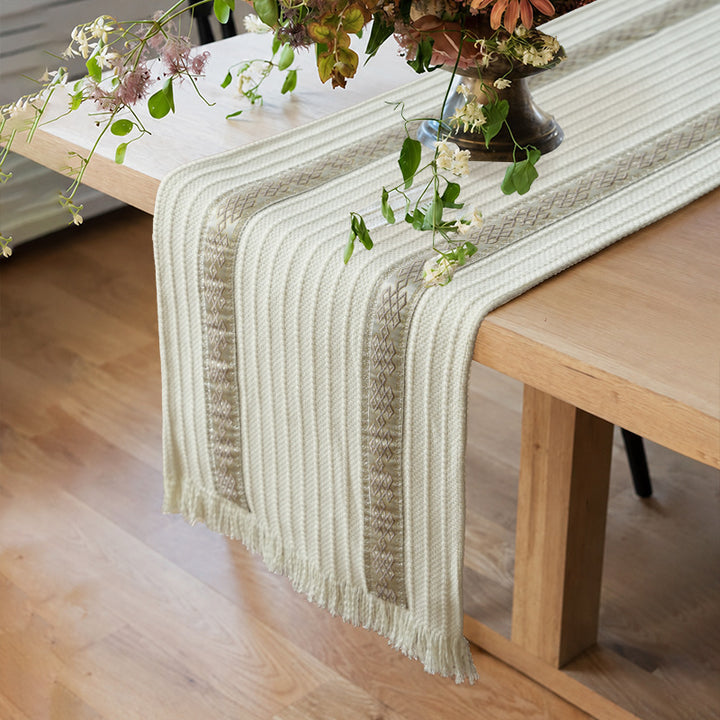 Woven table runner with contrasting center stripe, textured waffle look and decorative fringes