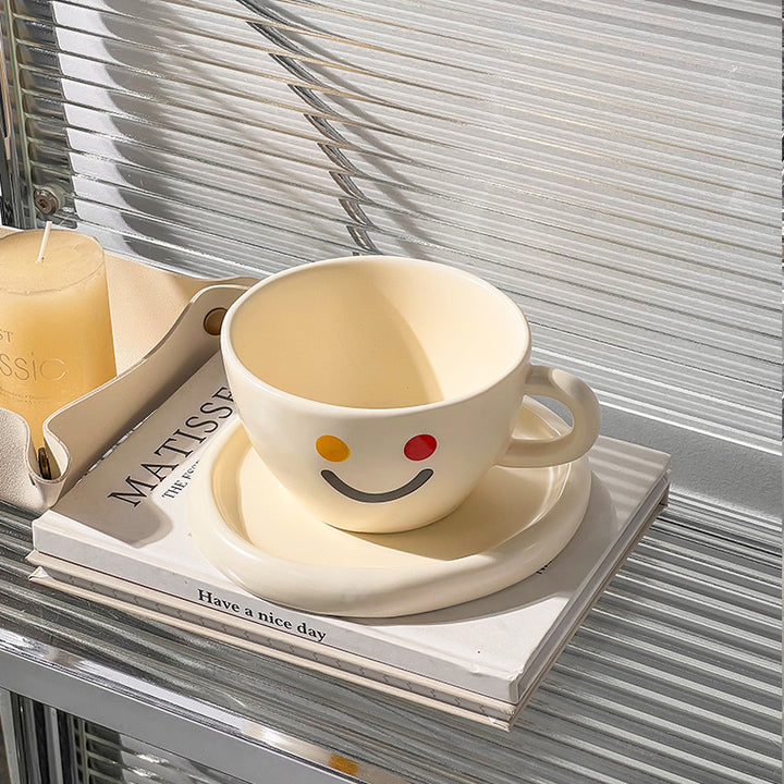 Handcrafted ceramic mug and plate set with cheerful smiley relief and organic shape