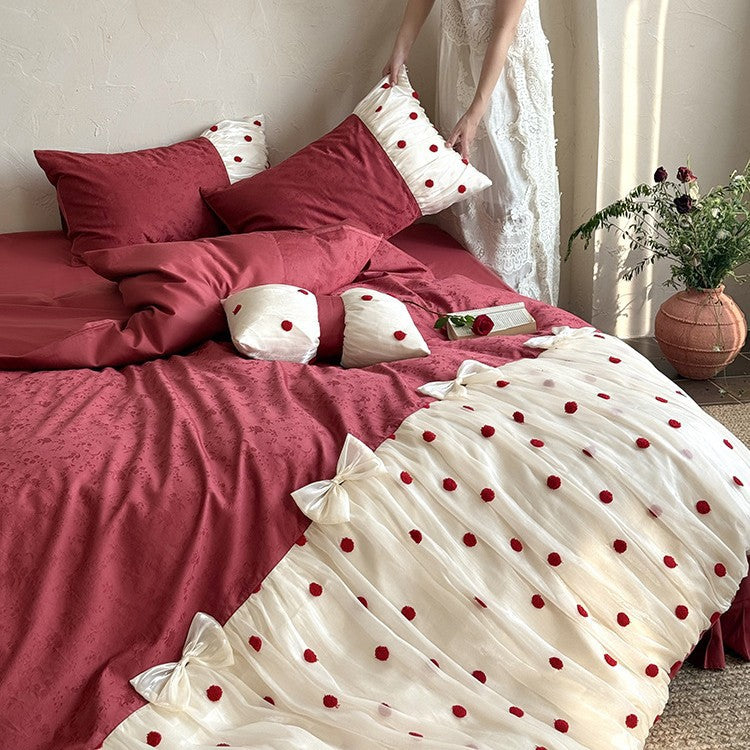 Romantic bed linen set with tulle overlay, pom pom appliqués, and decorative bows