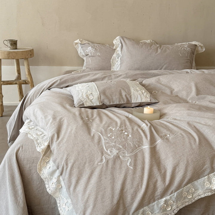 Vintage-inspired linen-cotton blend bedding set with floral chain stitch embroidery and lace trim