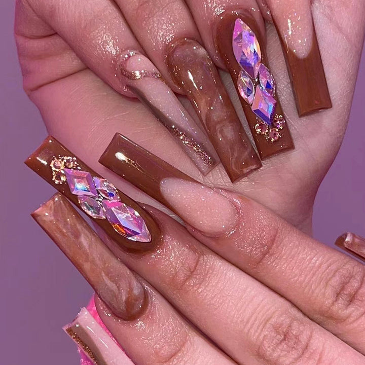 Artificial nail extensions with elegant gemstone embellishments Kalsten