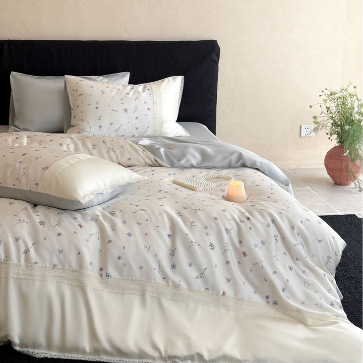 Cotton satin bedding set with delicate floral embroidery and lace trim