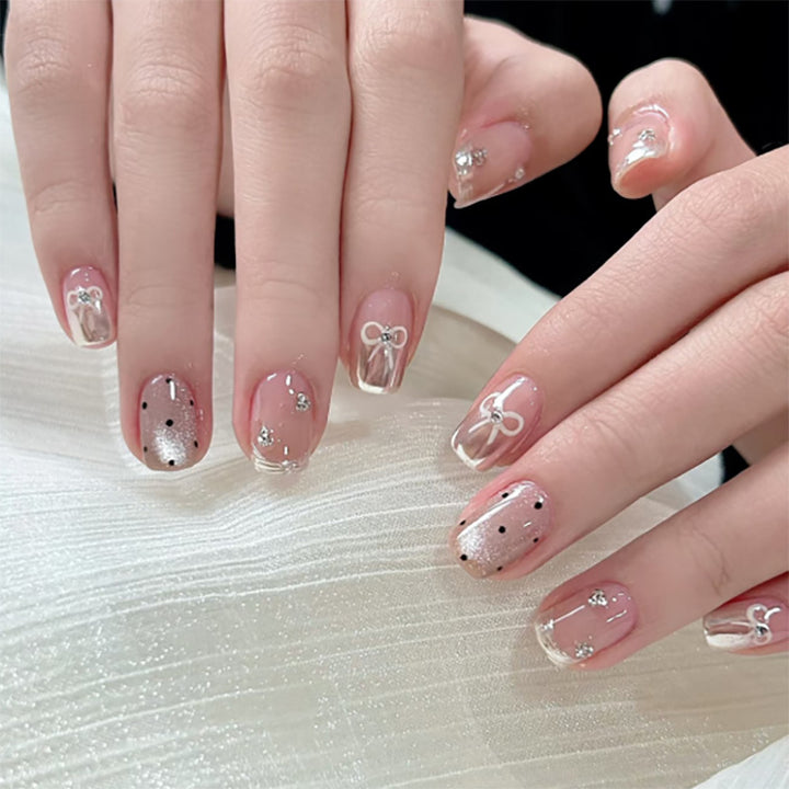 Artistic Nail Art with Bow and Glitter Accents Kalsten