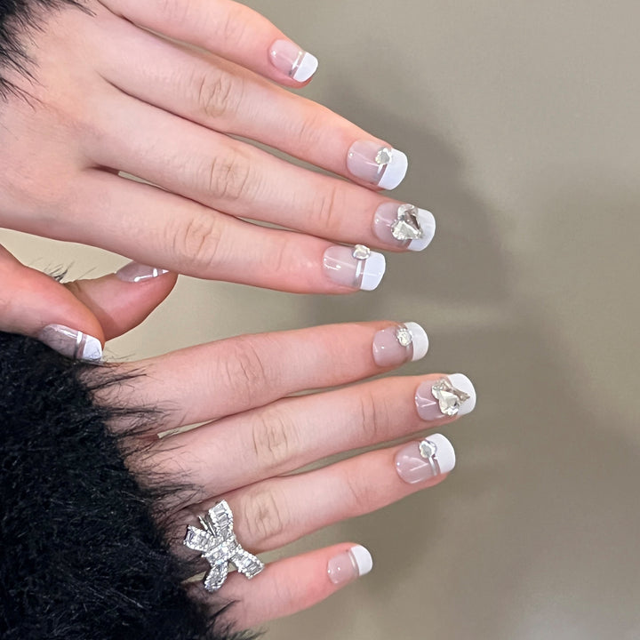 Elegant Nail Art with Glitter Accents and Jewelry Details Kalsten