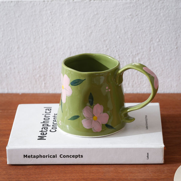 Hand-shaped ceramic mug with cloud relief and organic edge