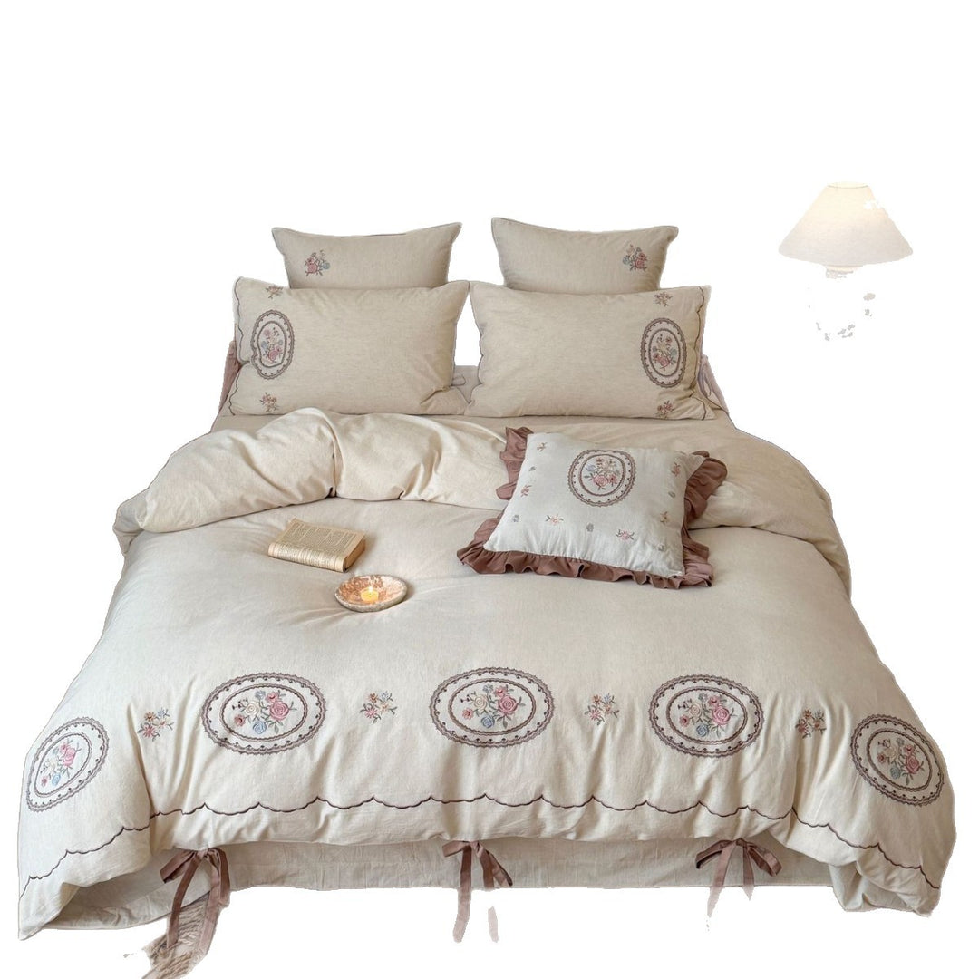 Romantic cotton-linen bedding set with embroidered flower medallions and ruffles