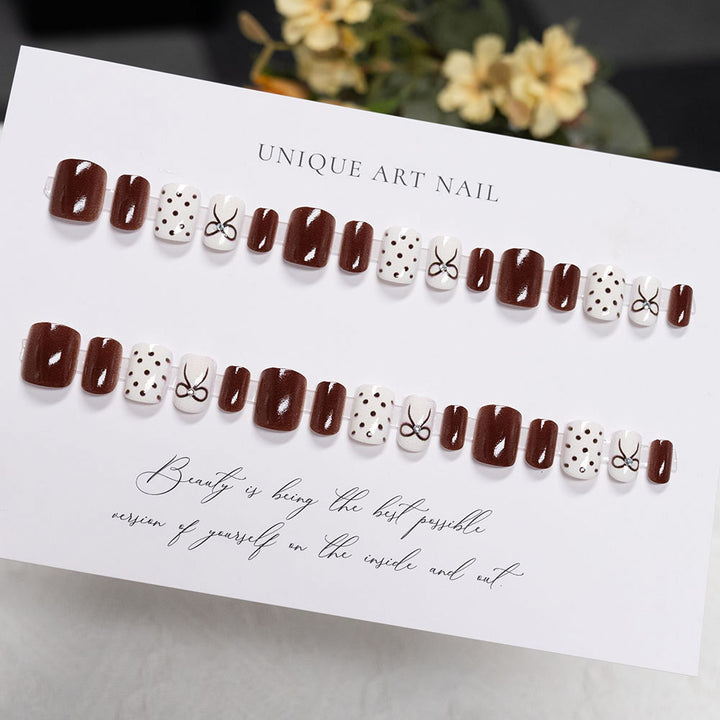 Decorative Press-On Nail Design with Bow and Polka Dots