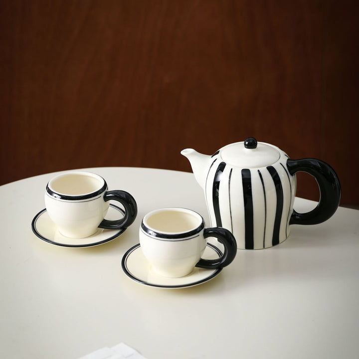 Porcelain tea set with vertical stripe decor and ergonomic handles