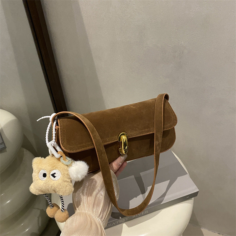 Elegant Suede Handbag with Playful Keychain