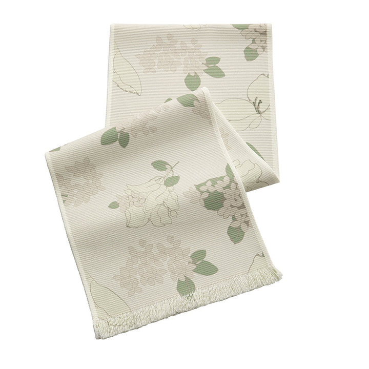 Woven botanical table runner with olive branch motif and fringed edge
