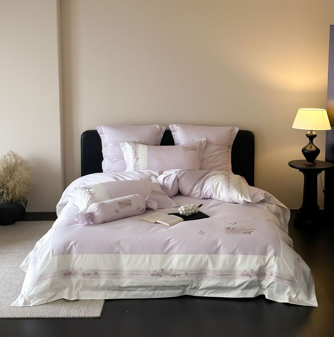 Luxurious cotton satin bed linen set with appliquéd flowers and decorative rolled hem