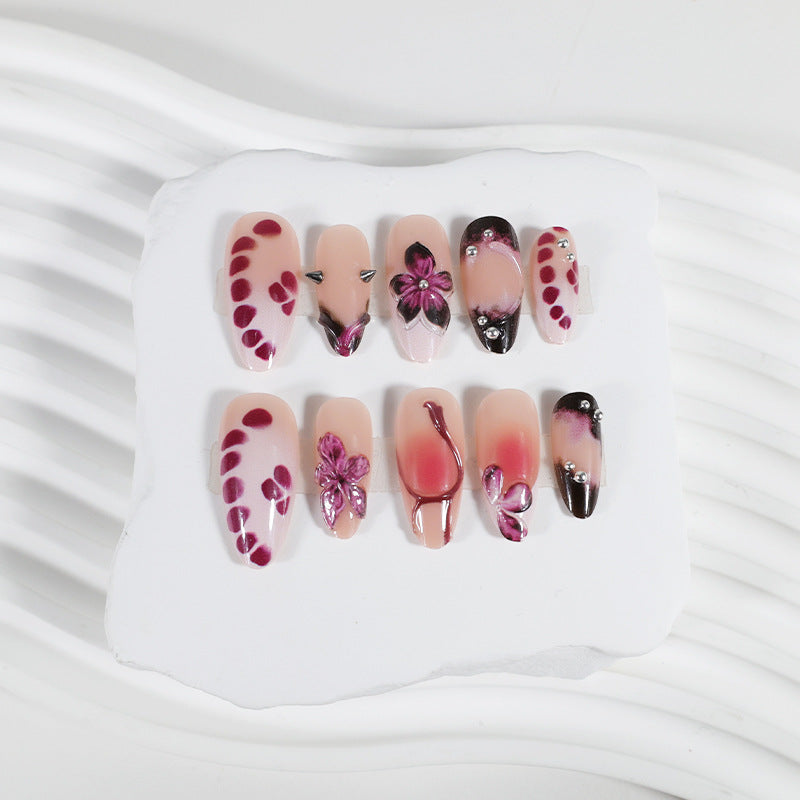 Acrylic nail set with elegant floral design and glossy accents Kalsten
