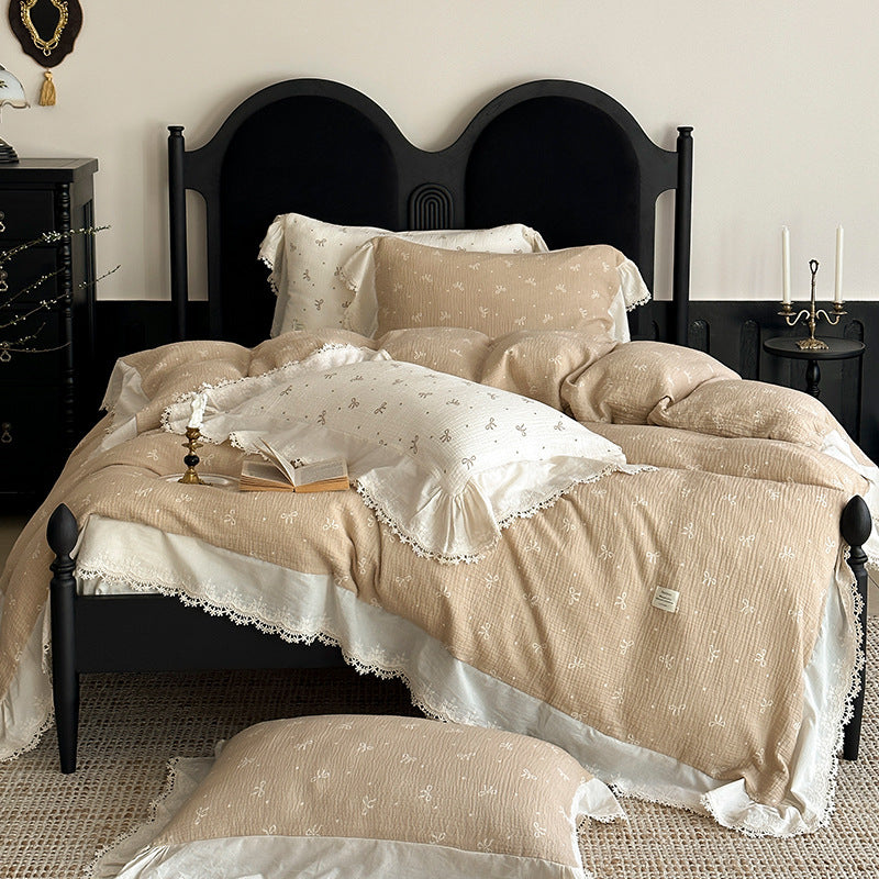 Cotton muslin bedding set with ruffles, lace trim, and delicate bow print