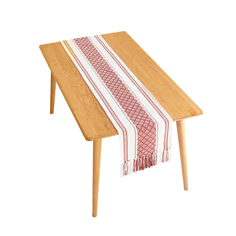 Handwoven cotton table runner with geometric center stripe and fringes