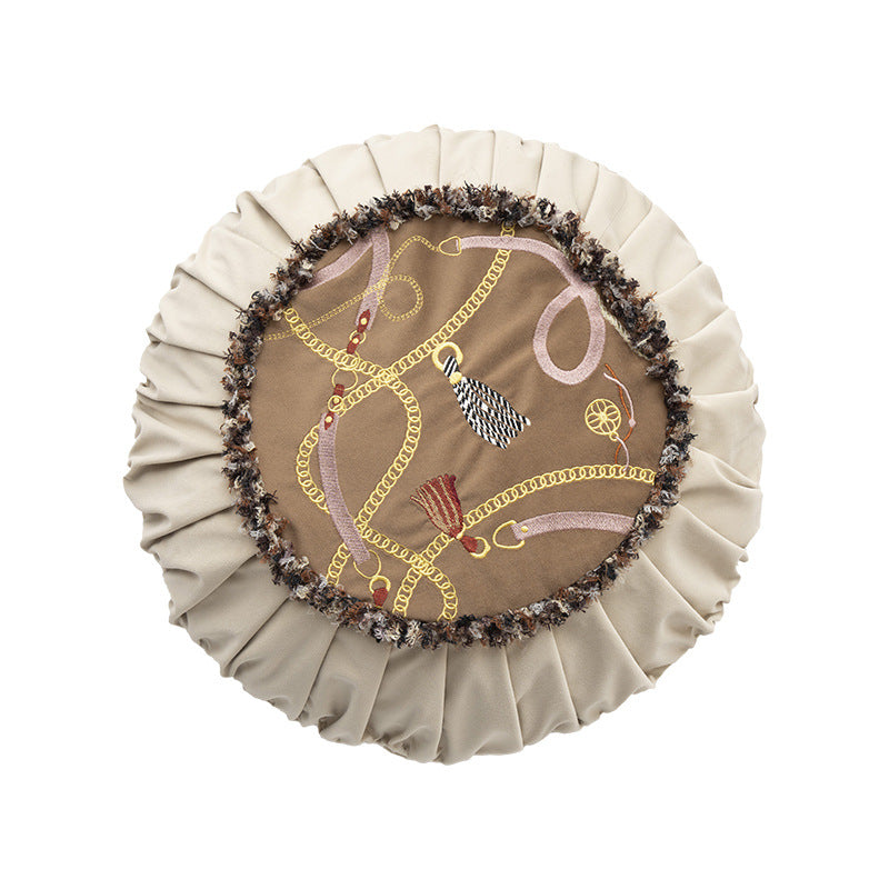 Round decorative cushion with pleated hem and embroidered central panel