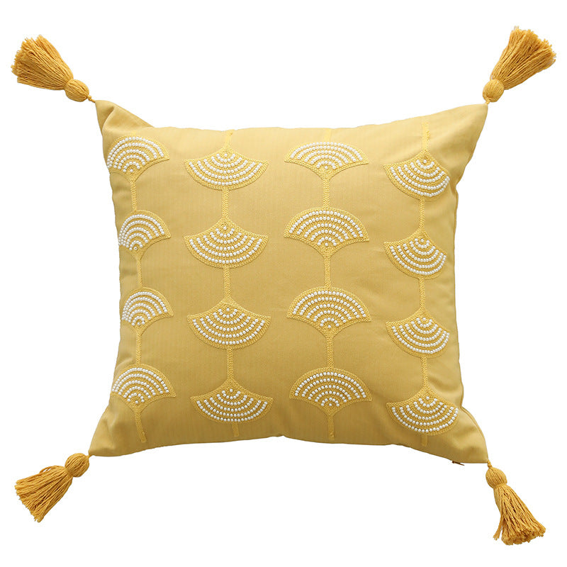 Square decorative pillow with embroidered fan motif and decorative tassels