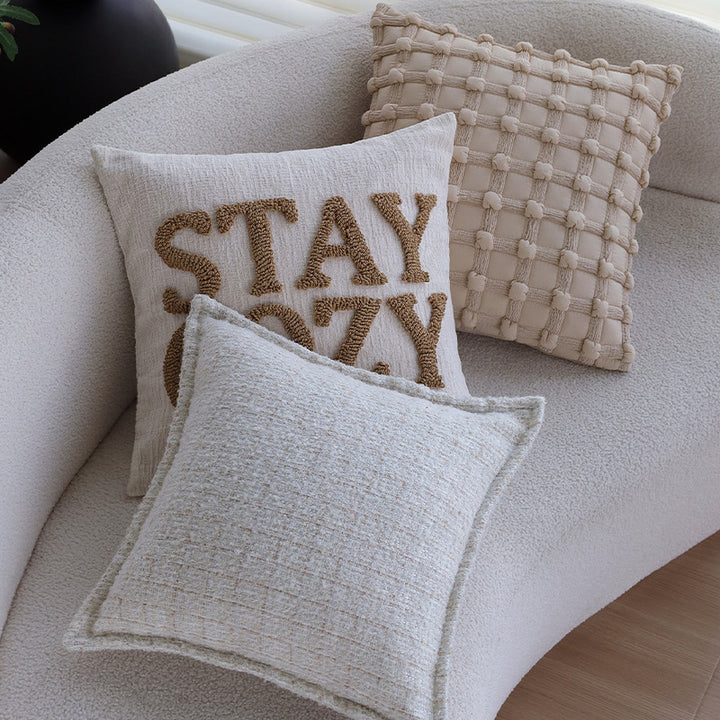 Square cushion cover made of textured bouclé blend with decorative piped seam Kalsten