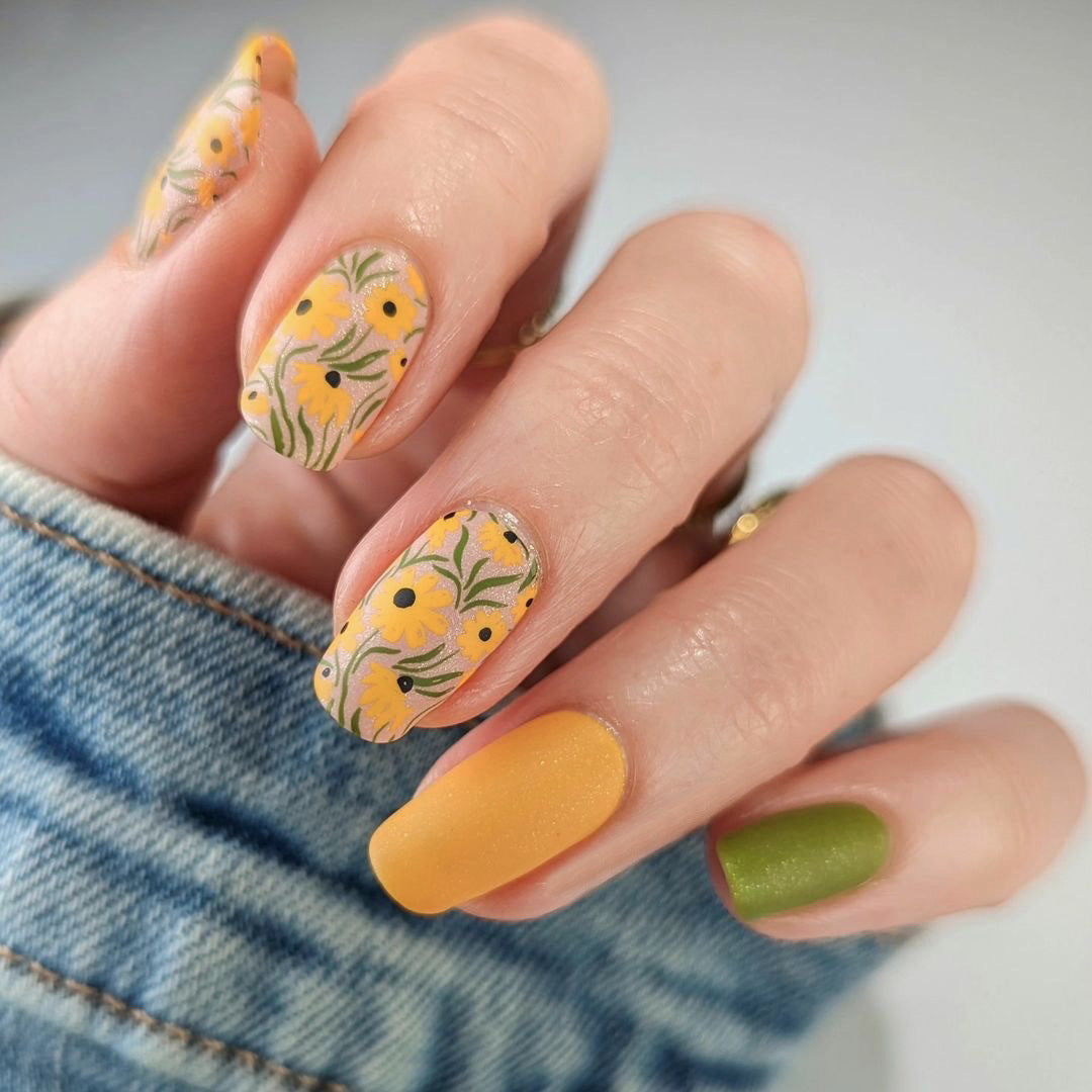 Artistic nail extensions with floral designs and creative color accents Kalsten