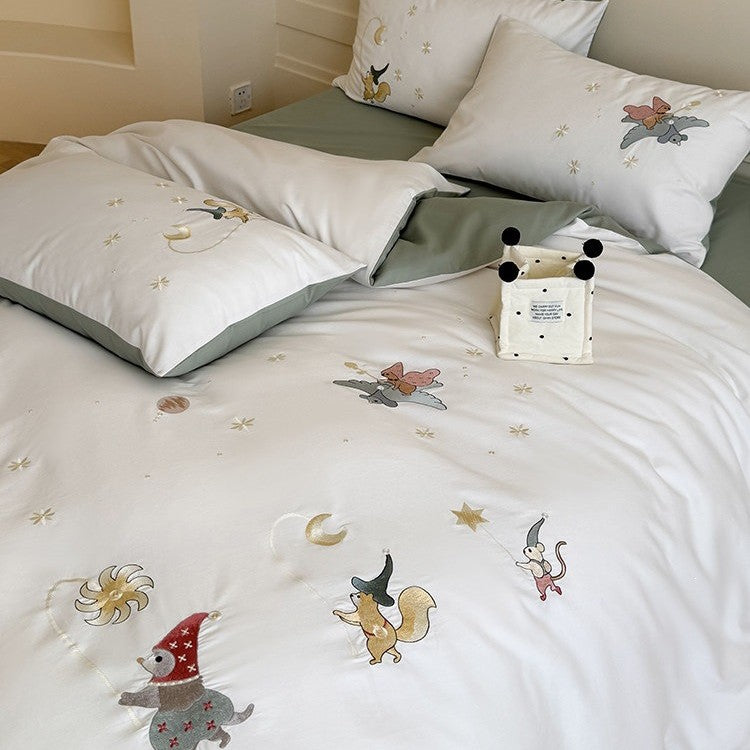 Children's bedding set with embroidered fairy tale forest motifs and reversible option