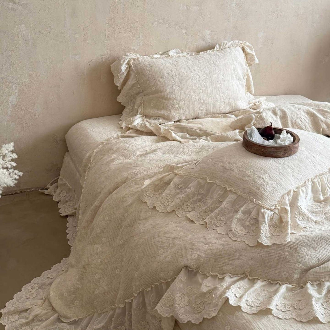 Vintage-inspired ruffled bedding set made of cotton muslin with fine floral embroidery