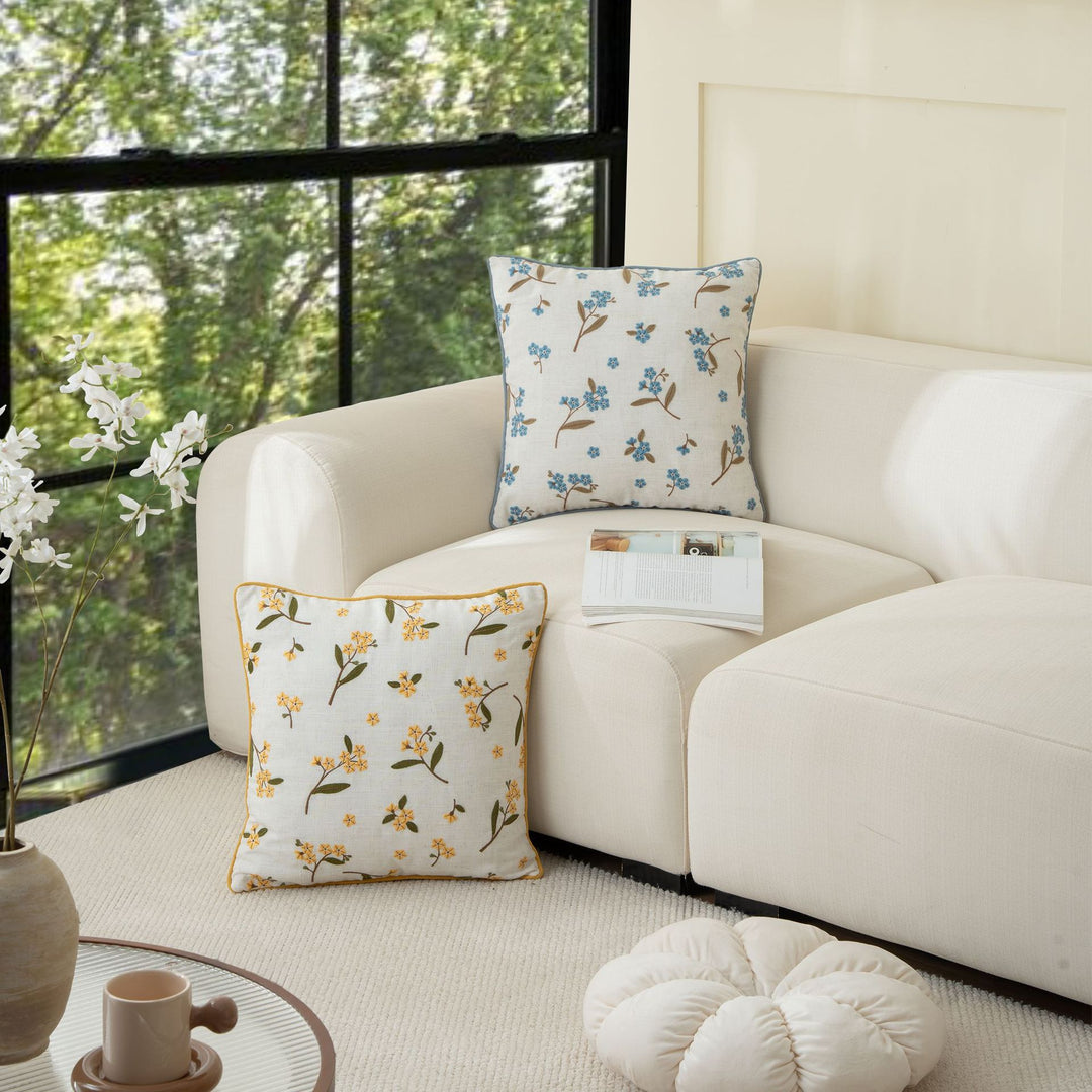 Embroidered linen decorative pillow with floral embroidery and piping