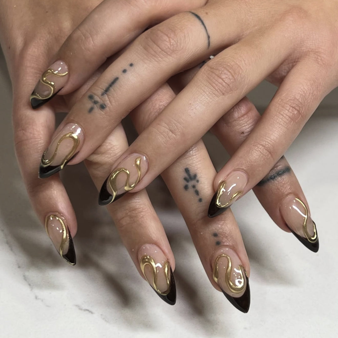 Artful stiletto nails with elegant gold design Kalsten
