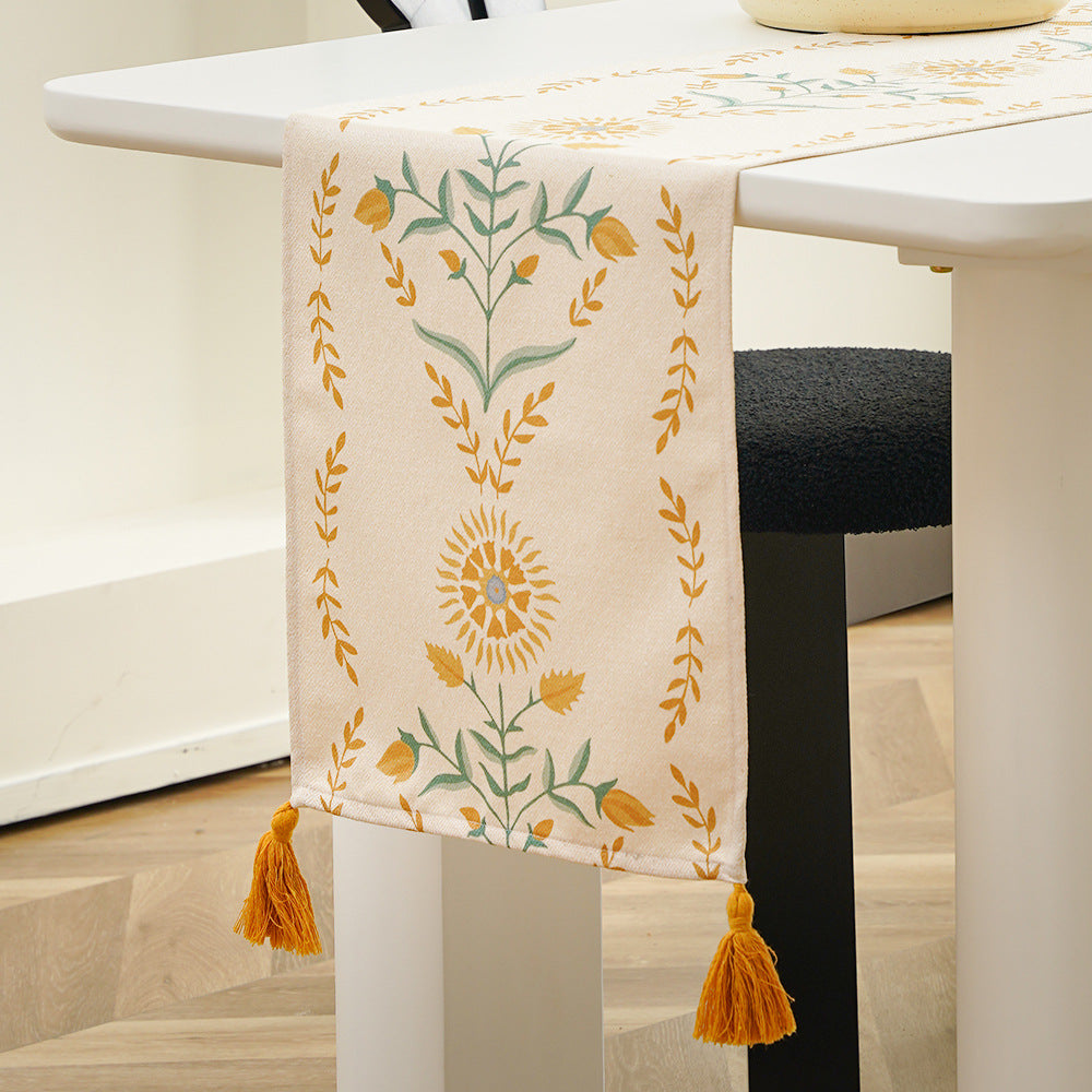 Table runner made of linen blend with floral block print motifs and tassels