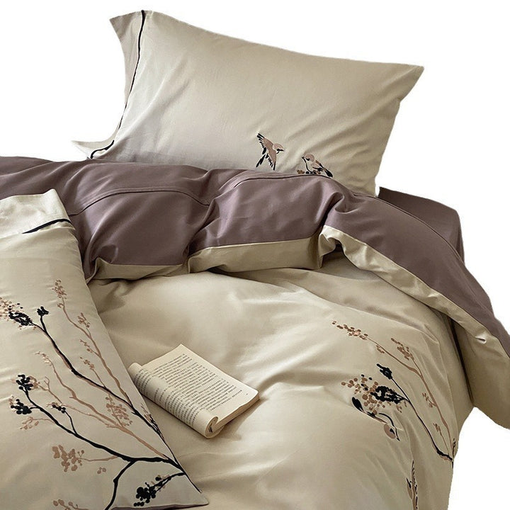 Reversible cotton satin bed set with finely embroidered bird and branch motifs