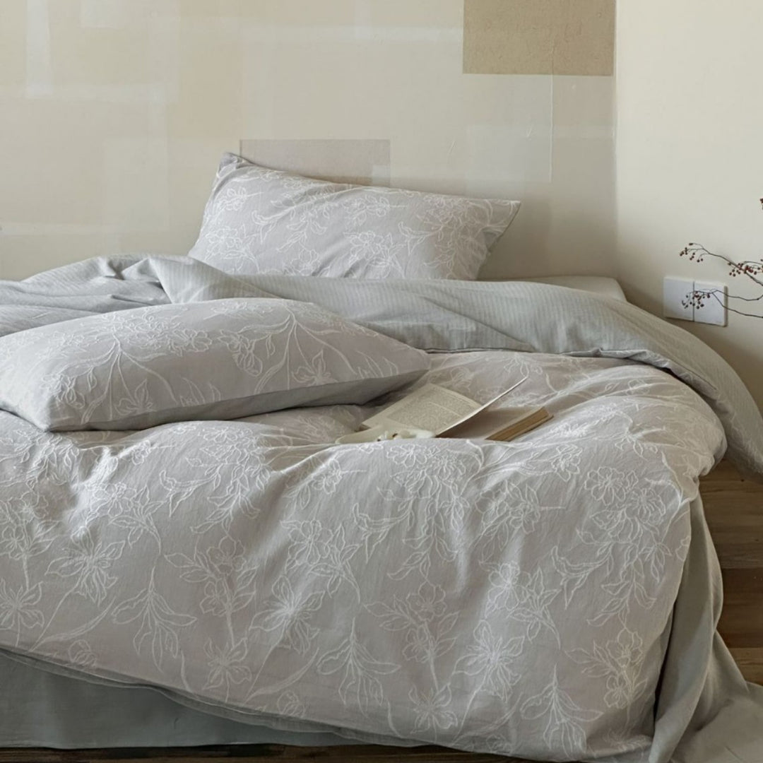 Finely woven cotton bedding set with embroidered floral relief and reversible cover