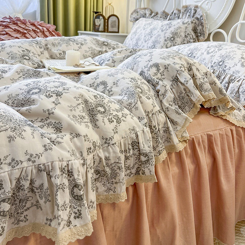 Romantic quilted comforter with ruffled border and fine floral pattern