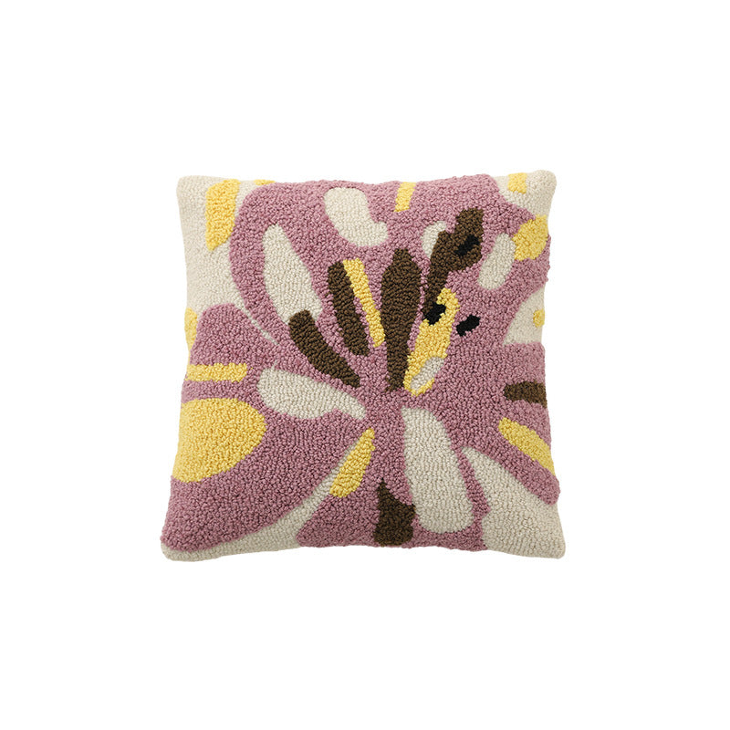 Hand-tufted decorative cushion with abstract graphic design and textured cotton surface