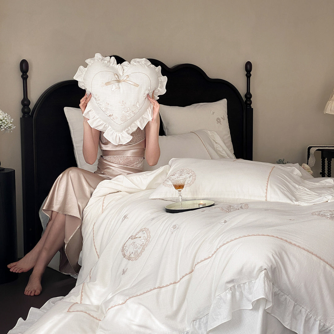 Romantic bedding set with ruffles, heart embroidery, and linen look