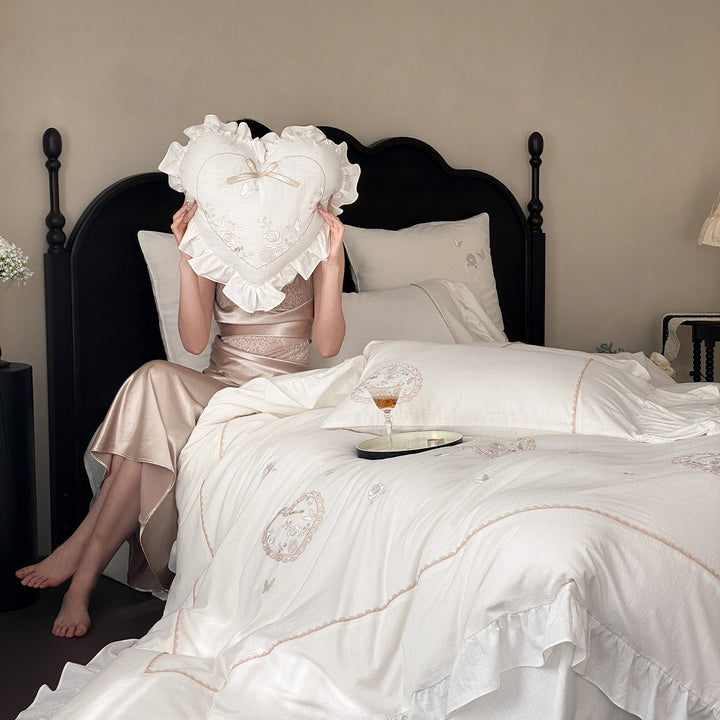 Romantic bedding set with ruffles, heart embroidery, and linen look