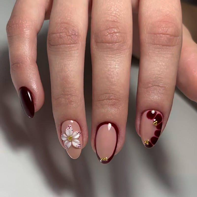 Acrylic nail set with elegant floral patterns and glamour accents Kalsten