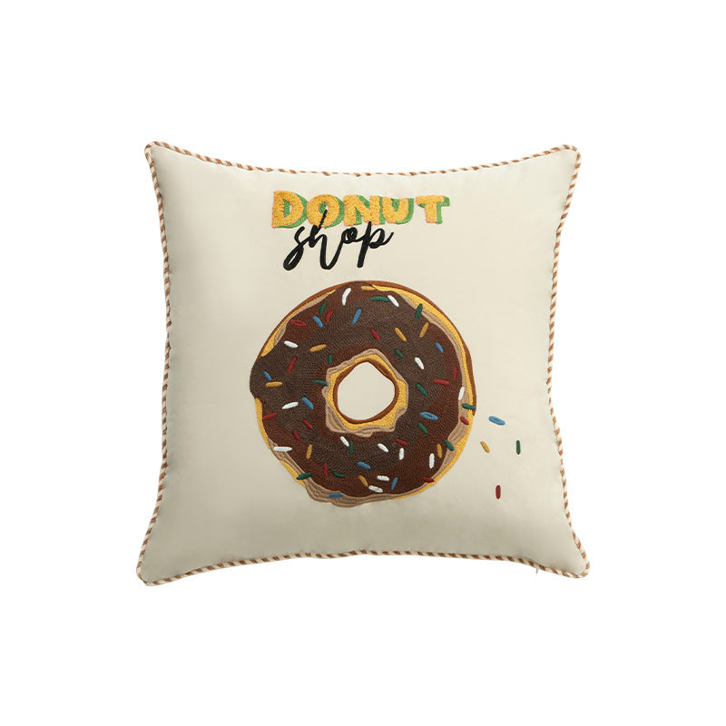 Square decorative cushion with embroidered donut motif and decorative piping edge