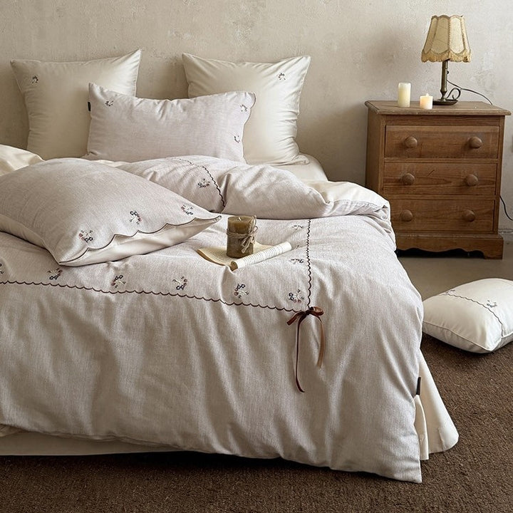Embroidered bed linen set made of cotton-linen with delicate floral embroidery, wavy edge and ties.