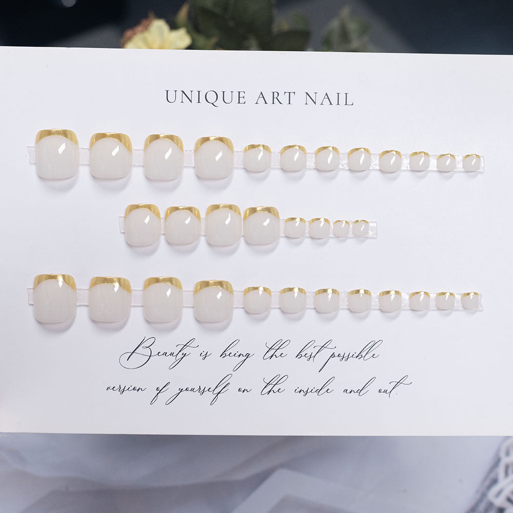 Press-On Nail Art with Elegant Gold Accents