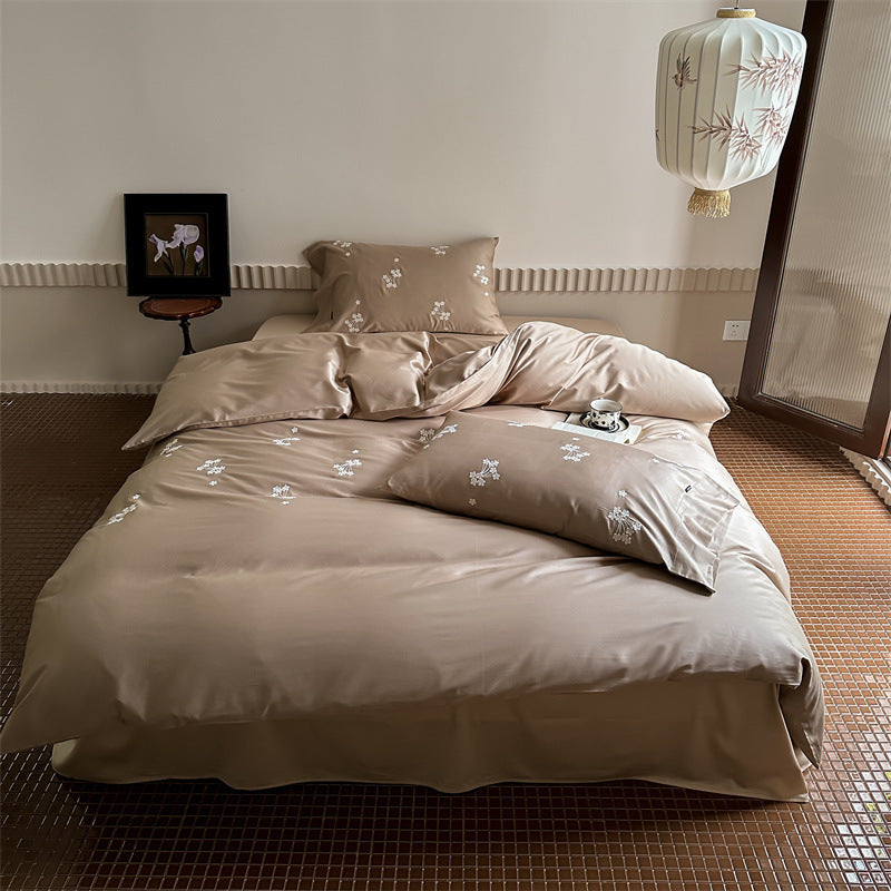 Elegant satin bed linen set with subtle floral embroidery and silk-like sheen