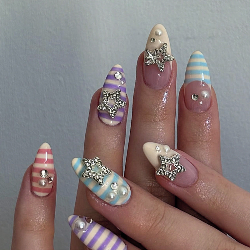 Artistic acrylic stiletto nails with glitter and star embellishments Kalsten