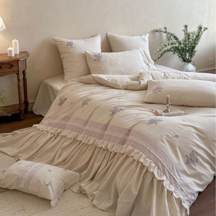 Vintage-inspired bedding set with ruffled bed skirt and delicate floral embroidery