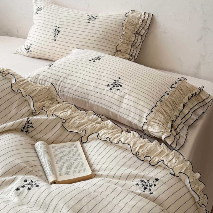 Romantic bedding set with ruffle, fine floral embroidery and pinstripes