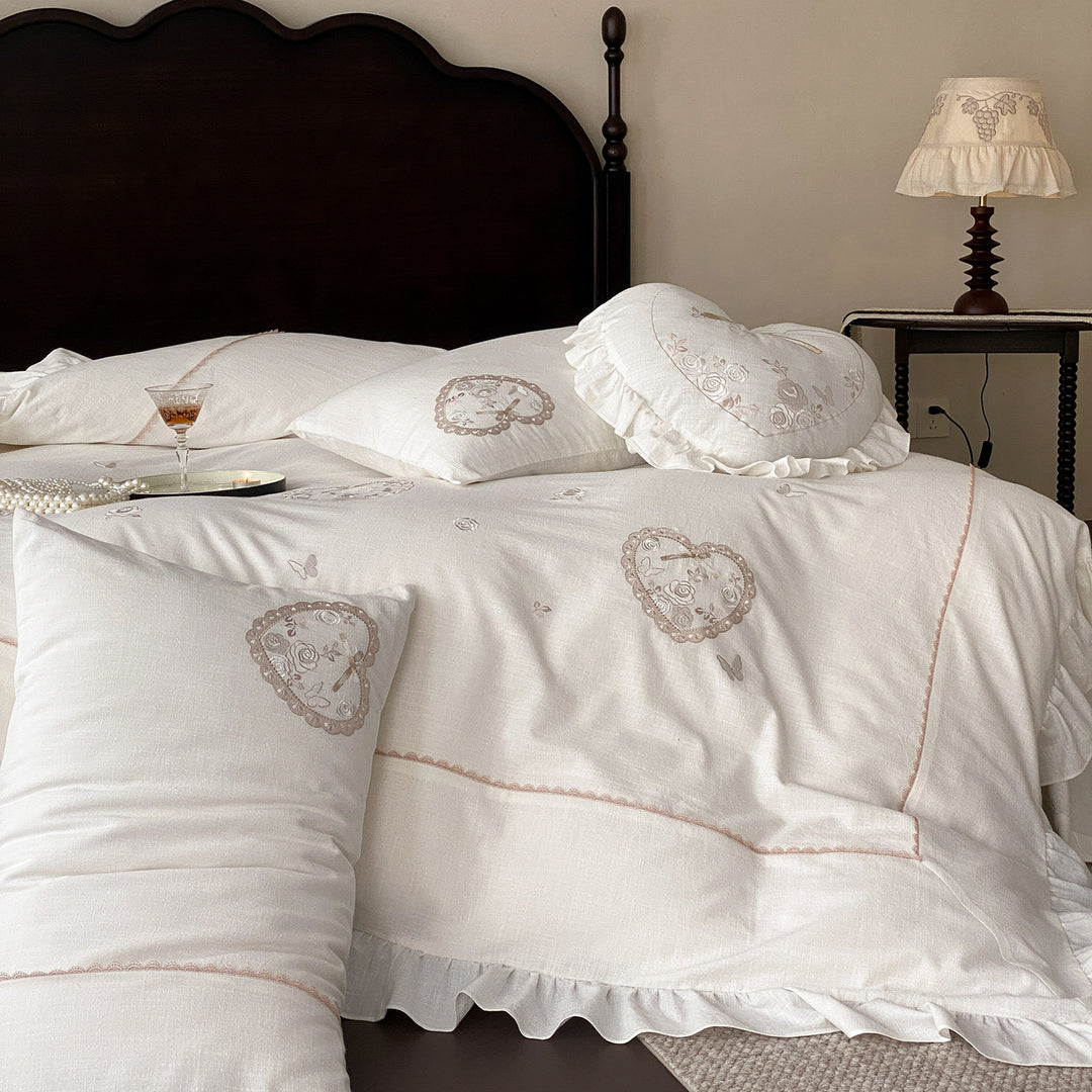 Romantic bedding set with ruffles, heart embroidery, and linen look
