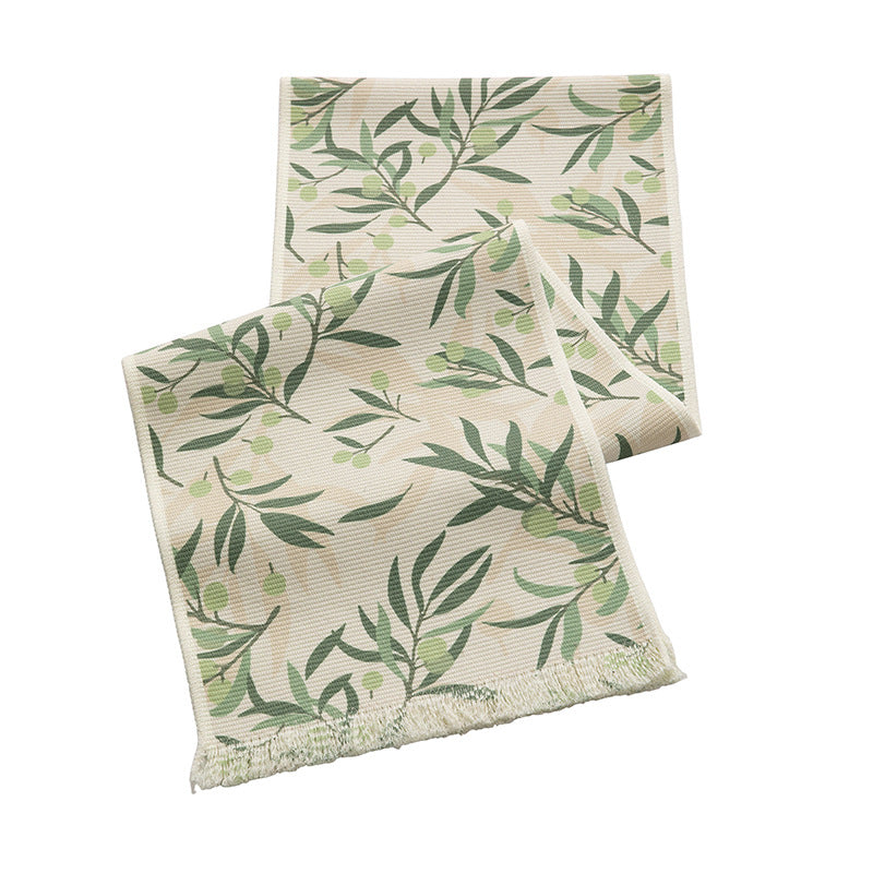 Woven botanical table runner with olive branch motif and fringed edge