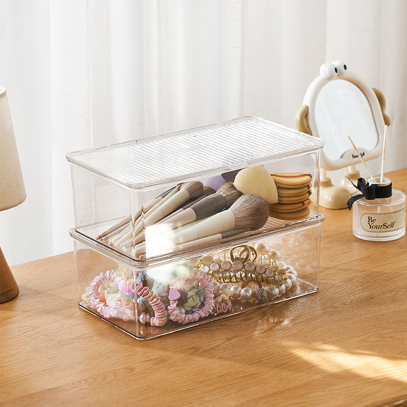 Transparent storage box with flip closure and ribbed lid surface