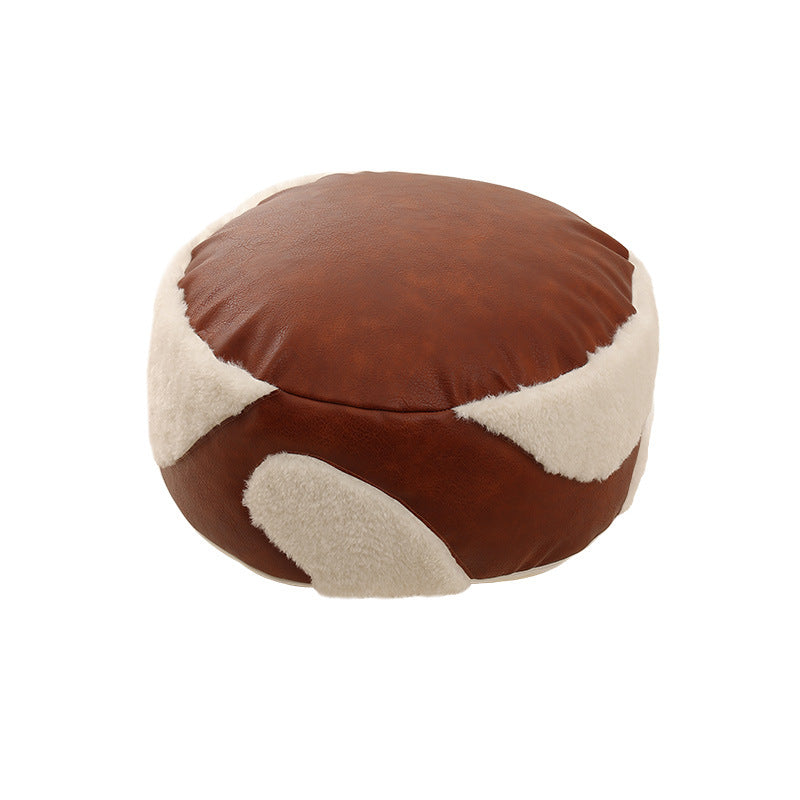 Round seating pouf with faux leather cover and Sherpa applications