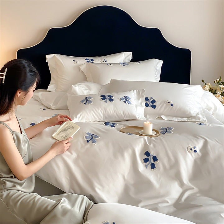 Embroidered cotton satin bedding set with subtle blue flower patterns