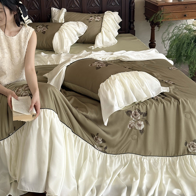 Romantic cotton satin bedding set with ruffled bed skirt and embroidered rose appliqués