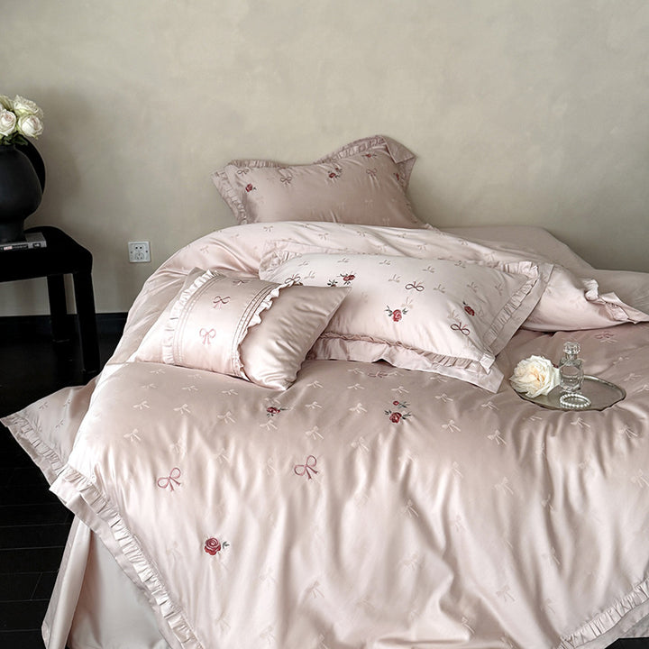 Luxurious satin bedding set with delicate floral embroidery and ruffles