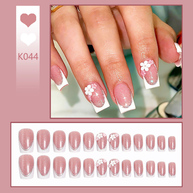 Acrylic nail set with elegant French tip and delicate floral decorations Kalsten