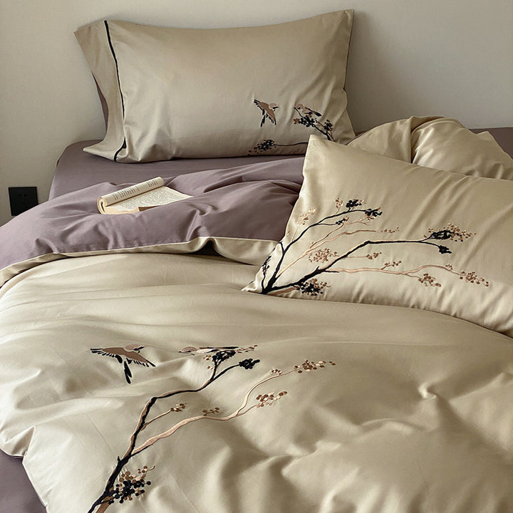 Reversible cotton satin bed set with finely embroidered bird and branch motifs